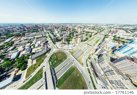 Aerial city view with crossroads and roads, houses, buildings, parks and parking lots. Sunny summer 57761146