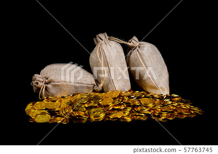 Lots of gold coin in treasure sack at black background Lots of gold coin in treasure sack at black background 57763745