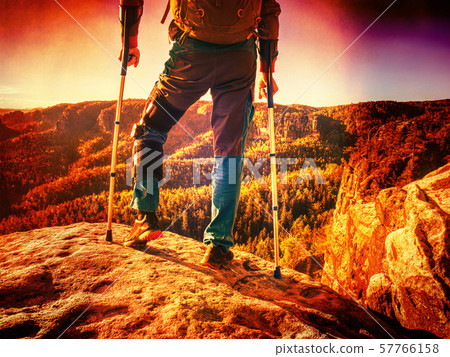 Accident tourist man walk by crutches on path Accident tourist man walk by crutches on path 57766158