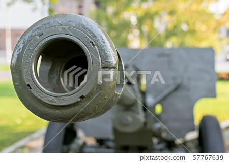 a sample of a military cannon close-up on the background of a residential area a sample of a military cannon close-up on the background of a residential area 57767639