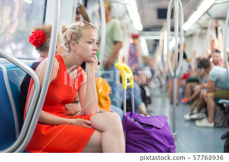 Lady traveling by metro. Lady traveling by metro. 57768936