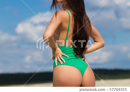Slim lady in green swimming suit Slim lady in green swimming suit 57769355