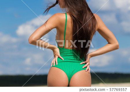 Slim lady in green swimming suit 57769357