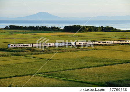 Muroran Main Line Limited Express Super Hokuto running through the countryside along Funka Bay 57769588