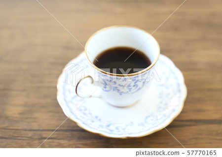 White cup & saucer with coffee 57770165