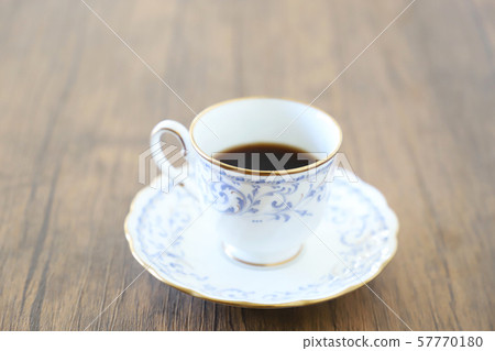 White cup & saucer with coffee 57770180