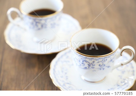 White cup & saucer with coffee 57770185