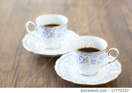 White cup & saucer with coffee 57770187