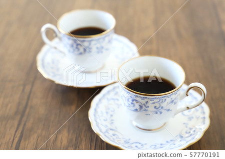 White cup & saucer with coffee 57770191