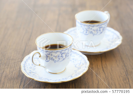 White cup & saucer with coffee 57770195