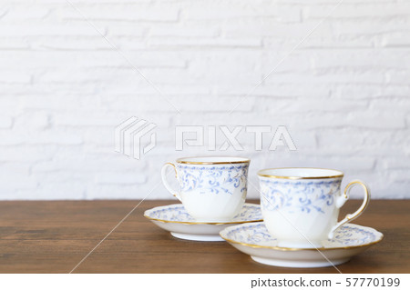 White cup & saucer with coffee 57770199