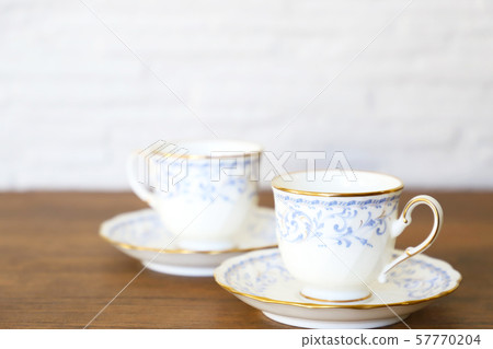 White cup & saucer with coffee 57770204