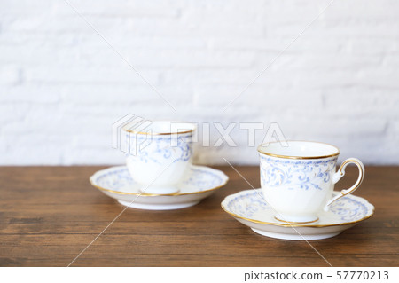 White cup & saucer with coffee 57770213