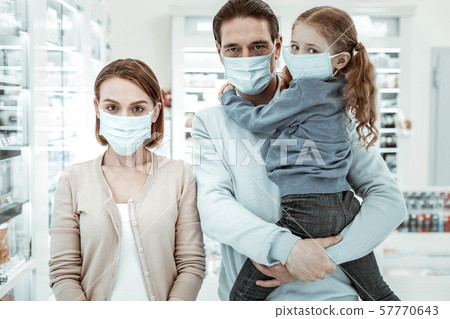 Family in the drugstore wearing a medical face mask Family in the drugstore wearing a medical face mask 57770643
