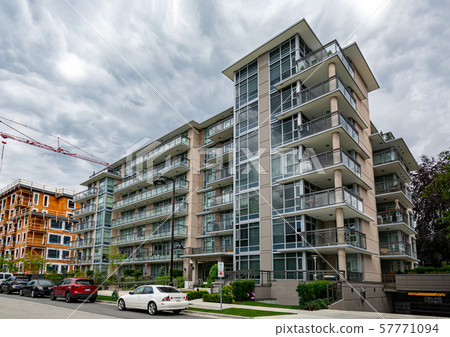 New residential low-rise building with cars parked on the street New residential low-rise building with cars parked on the street 57771094