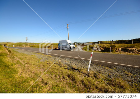 A camper van along a rural road in New Zealand 57773074