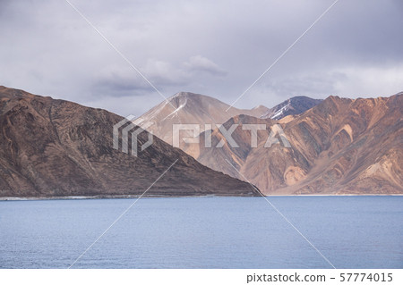 Pangong Lake with rocky mountains situated on the Pangong Lake with rocky mountains situated on the 57774015
