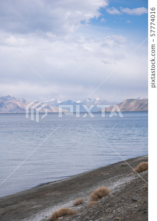 Pangong Lake with rocky mountains situated on the Pangong Lake with rocky mountains situated on the 57774016