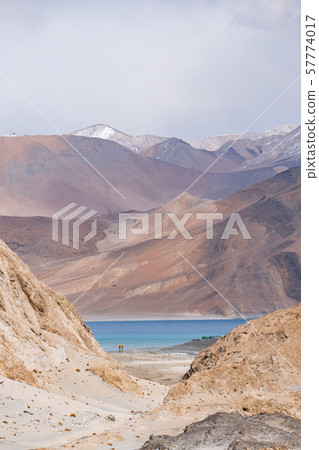 Pangong Lake with rocky mountains situated on the Pangong Lake with rocky mountains situated on the 57774017
