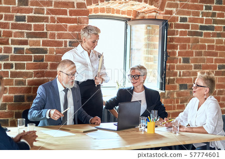 Group of business people brainstorming together in meeting room Group of business people brainstorming together in meeting room 57774601