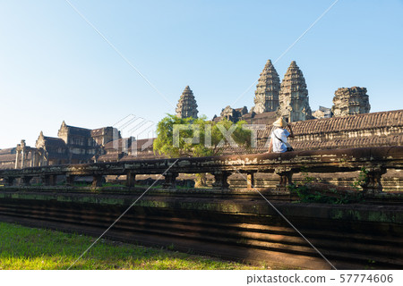 One tourist visiting Angkor ruins amid jungle, One tourist visiting Angkor ruins amid jungle, 57774606