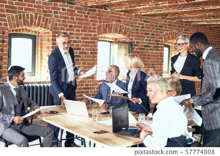 Group of business people brainstorming together in meeting room Group of business people brainstorming together in meeting room 57774808