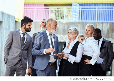 Group of businessmen walking down the street 57774889