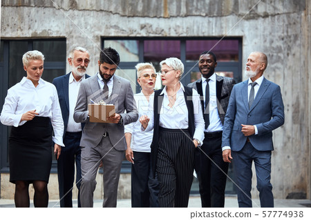 Group of businessmen discuss project outdoor Group of businessmen discuss project outdoor 57774938