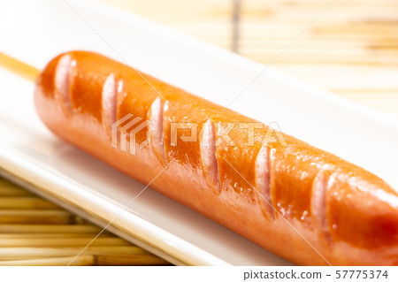 A frank with a skewer (a frankfurter sausage on a skewer). A frank with a skewer (a frankfurter sausage on a skewer). 57775374