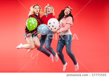 Laughing woman having fun jumping and smiling with 57775505