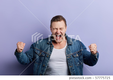 crazy funny man rejoicing at his victory, winning 57775725