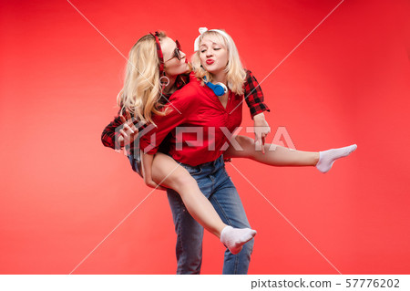Sisters having fun giving piggyback.Stock studio Sisters having fun giving piggyback.Stock studio 57776202