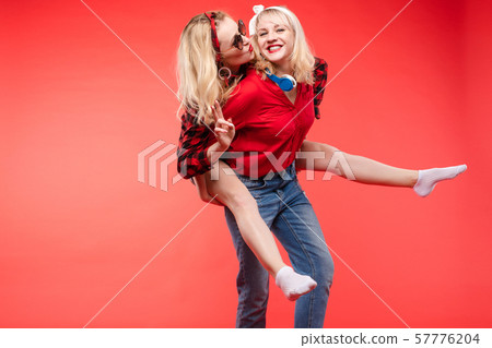 Sisters having fun giving piggyback.Stock studio Sisters having fun giving piggyback.Stock studio 57776204