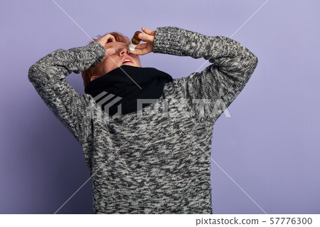 sick man dripping nasal drops sick man dripping nasal drops 57776300