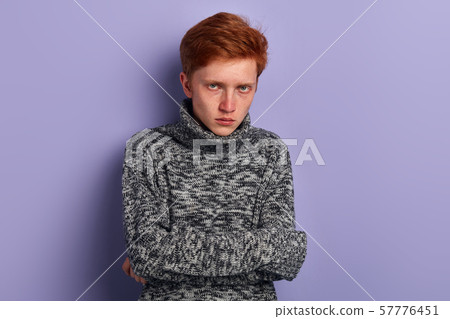 poor unhappy serious man hugging himself , feeling cold poor unhappy serious man hugging himself , feeling cold 57776451