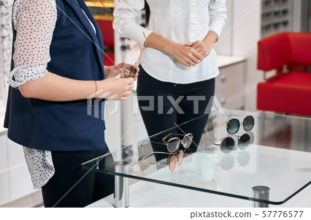 focus on different glasses, sunglassses lying on the glass table focus on different glasses, sunglassses lying on the glass table 57776577