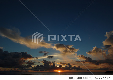 Sunset orange and blue sky and thunderhead Sunset orange and blue sky and thunderhead 57776647