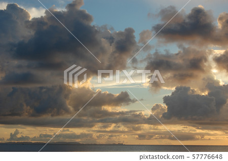 Golden sky with blue sky and clouds at sunset Golden sky with blue sky and clouds at sunset 57776648