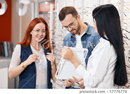 attractive couple having fun at optical store 57776778