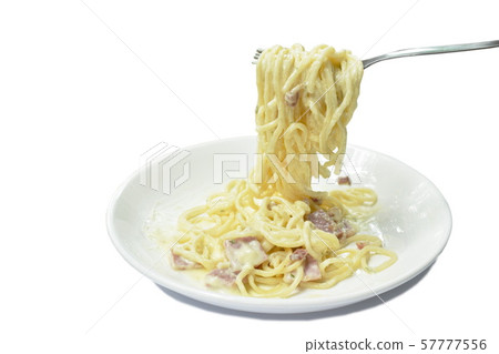 spaghetti white cream sauce topping slice ham pork rolled in fork on dish 57777556