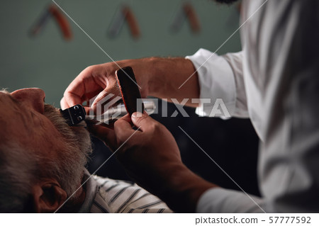 process of trimming beard , close up side view cropped photo 57777592