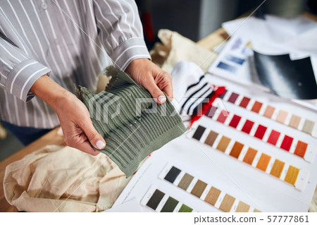 tailor holding color samples choosing fabric textile at workplace 57777861