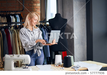 cheerful blonde woman surfing the net, browsing the internet, sending e-mail cheerful blonde woman surfing the net, browsing the internet, sending e-mail 57777936