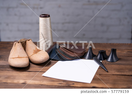 Leather samples for shoes and wooden shoe last on 57779159