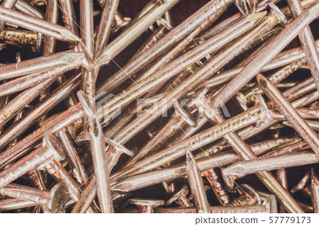 Texture of yellow nails on red background. Texture of yellow nails on red background. 57779173