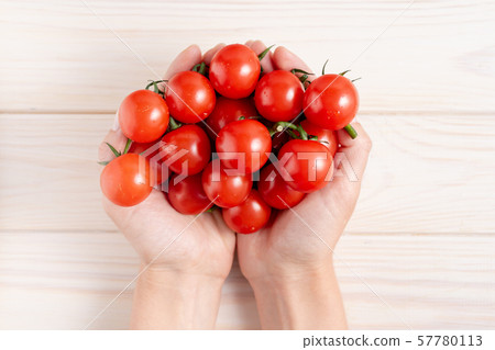 Cherry tomatoes on the white wooden table 57780113