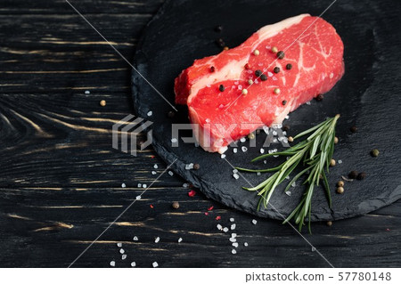 One pieces of juicy raw beef on a stone cutting One pieces of juicy raw beef on a stone cutting 57780148