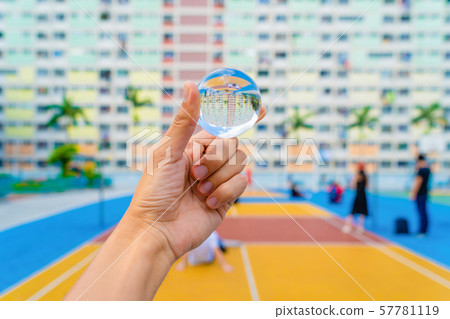 Hand holding a glass or crystal ball at colorful Hand holding a glass or crystal ball at colorful 57781119