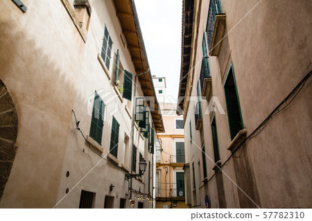 Majorca cityscape Houses with cream and stone walls with windows with green black doors 57782310