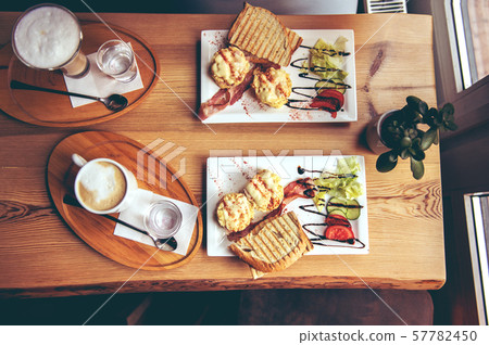 breakfast with scrambled eggs, toasts, juice and coffee 57782450